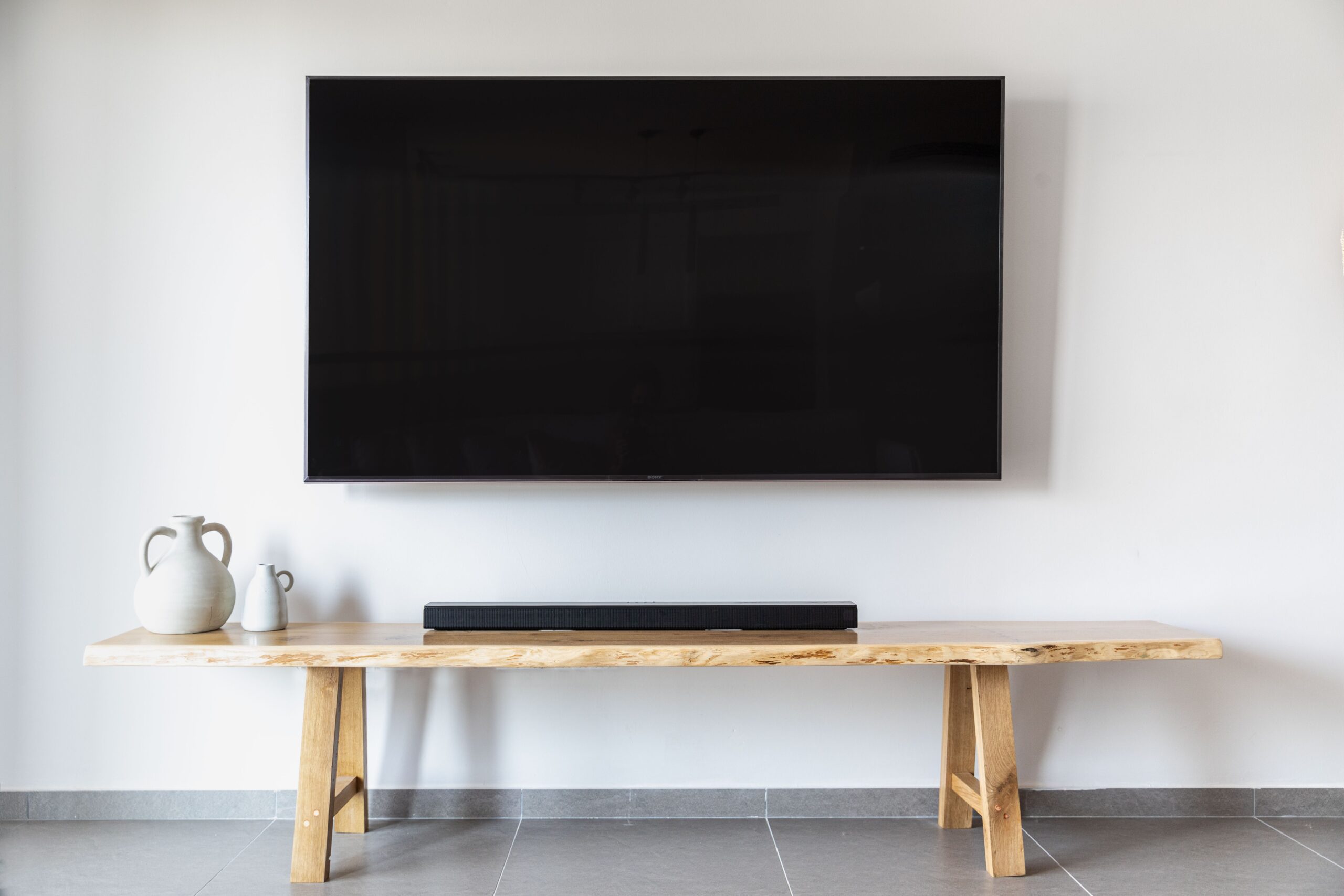 A flat screen TV mounted on a white wall